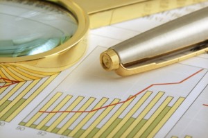 financial forecasts, beautiful pen, and paper, all in gold color